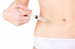 Syringe On Woman's Stomach Stock Photo