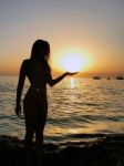 Beautiful Girl Silhouette Standing In The Sand During A Sunset On Golden Bay, Malta Stock Photo