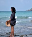 Lonely Woman Walking On The Beach Stock Photo