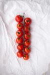 Organic Fresh Cherry Tomatoes On White Paper Background Stock Photo