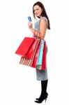 Young Woman Holding Shopping Bags And Credit Card Stock Photo