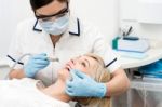 Patient Getting Treatment From Dentist Stock Photo