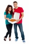 Young Couple Holding Pizza Box Stock Photo