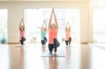 Asian Woman Doing Yoga Indoors Stock Photo