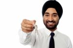 Smiling Corporate Guy Holding A Key Stock Photo