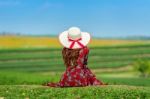 Woman Sitting On Green Grass In Green Tea Field Stock Photo