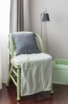 Green Wooden Chair With Grey Pillow And Green Blanket Stock Photo