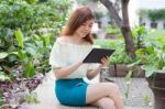 Portrait Of Thai Adult Businesswoman Beautiful Girl Using Her Tablet Stock Photo