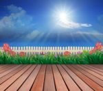 Wood Terrace And Flowers Garden With Blue Sky And Sunshine Above Stock Photo