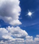 Blue Sky With White Clouds And Sun Stock Photo