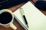 Pen On Notebook With Computer Keyboard, Mouse And A Cup Of Coffe Stock Photo