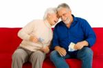 Elderly Couple Holding Money Stock Photo