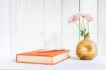 Books Or Journal With Flowers Arranged On A Neutral White Painted Desk Stock Photo