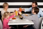 Family Toasting Smoothies In Restaurant Stock Photo