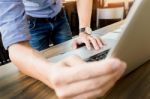 Attractive  Man In Casual Business Sitting At A Table Working On Stock Photo