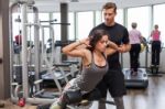 Woman With Personal Trainer  In Gym Stock Photo