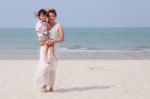 Woman And Son Walking On Beach Stock Photo