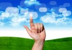 Hand Pushing Button On Blue Sky Stock Photo