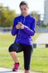 Pretty Young Woman Listening To Music After Running Stock Photo