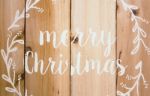 Merry Christmas Written On Sodden Planks Background Stock Photo