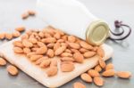 Almond Nuts On Wooden Plate With Milk Stock Photo