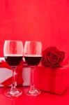 St Valentine's Setting With Present And Red Wine Stock Photo