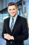 Smiling Businessman Posing Confidently Stock Photo