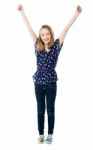 Smiling Girl With Raised Arms Stock Photo