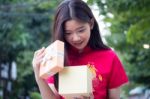 Portrait Of Thai Teen Beautiful Girl In Chinese Dress, Happy New Year And Open Box Gift, Smile And Very Happy Stock Photo