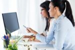 Two Business Woman Working In Office With Computer Stock Photo