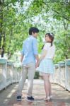 Loving Asian Couple Under Tree In The Park Stock Photo