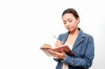 Women Write In A Book Stock Photo