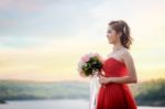 Beautiful Woman Wear Red Evening Dress Hold A Bouquet Of Flowers Stock Photo