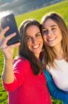 A Group Of Friends Taking Photos With A Smartphone Stock Photo