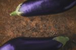 Eggplants On The Brown Stone Background  Horizontal Stock Photo