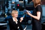 Corporate Lady Swiping Her Card To Pay Stock Photo