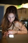 Brunette In Kitchen With Mobile Phone Stock Photo