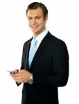 Smiling Businessman Holding Mobile Stock Photo