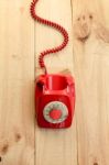 Red Landline Earphone And Cable On Wood Background Stock Photo