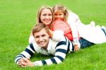 Lying Family In Outdoors Stock Photo