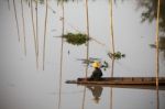 Fisherman Sitting On Boat Stock Photo