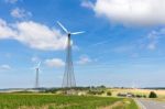 Two Windmills In Rural Area With Blue Sky Stock Photo