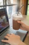 Woman Using Laptop In The Coffee Shop Stock Photo