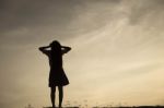 Silhouette Of Woman Praying Over Beautiful Sky Background Stock Photo