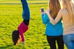 A Group Of Friends Taking Photos With A Smartphone Stock Photo