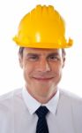 Smiling Engineer Wearing Helmet Stock Photo