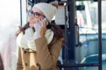 Young Beautiful Woman Using Her Mobile Phone On A  Bus Stock Photo