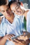 Young Couple Using A Digital Tablet Stock Photo