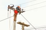 An Electrical Power Utility Worker In A Bucket Fixes The Power Line Stock Photo