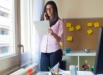 Beautiful Young Woman Working In Her Office Stock Photo